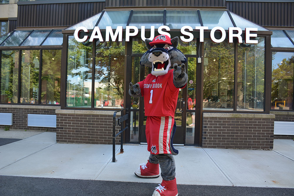 Wolfie standing in front of the SBU Campus Store front entrance