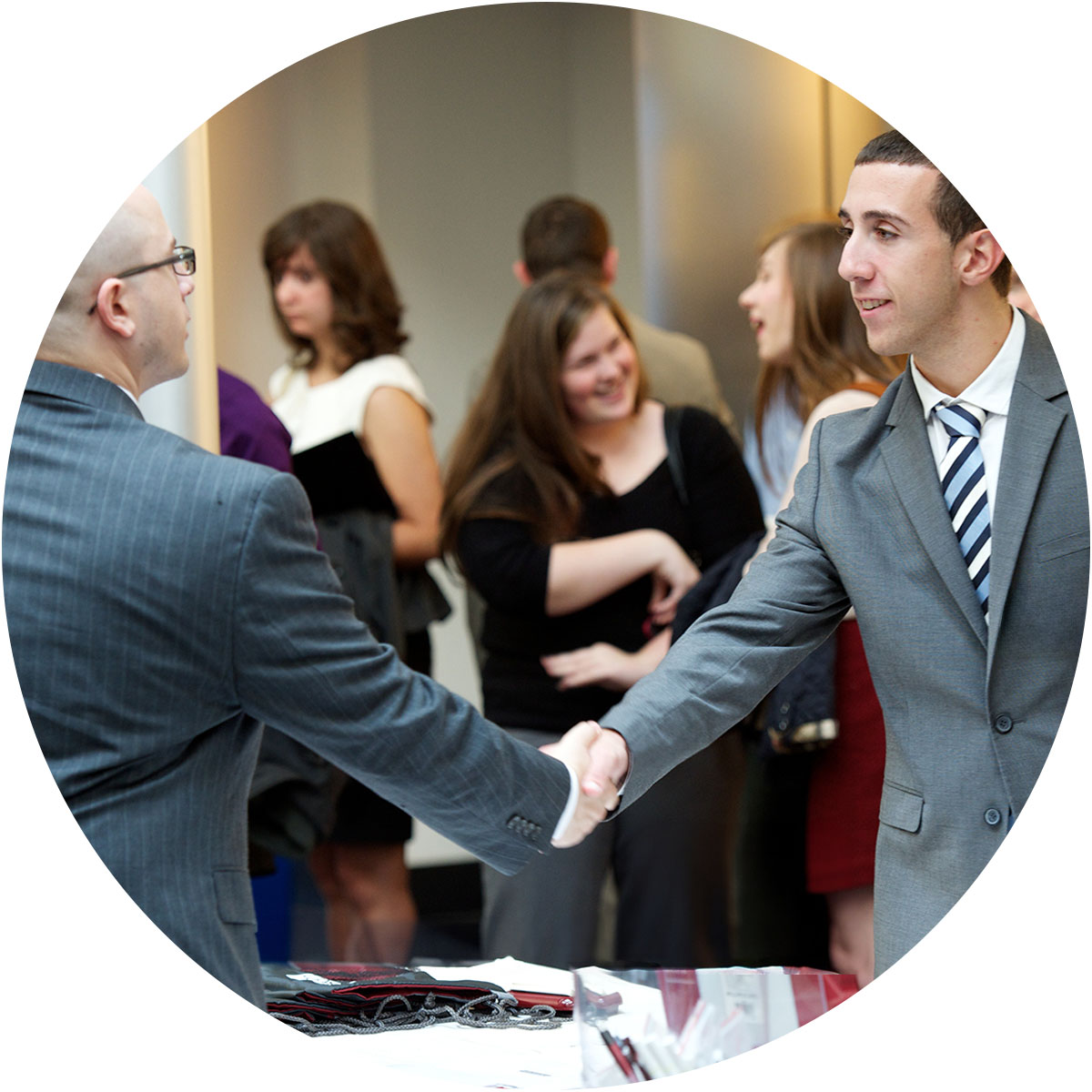 College of Business MS Student networking at an event with business professionals