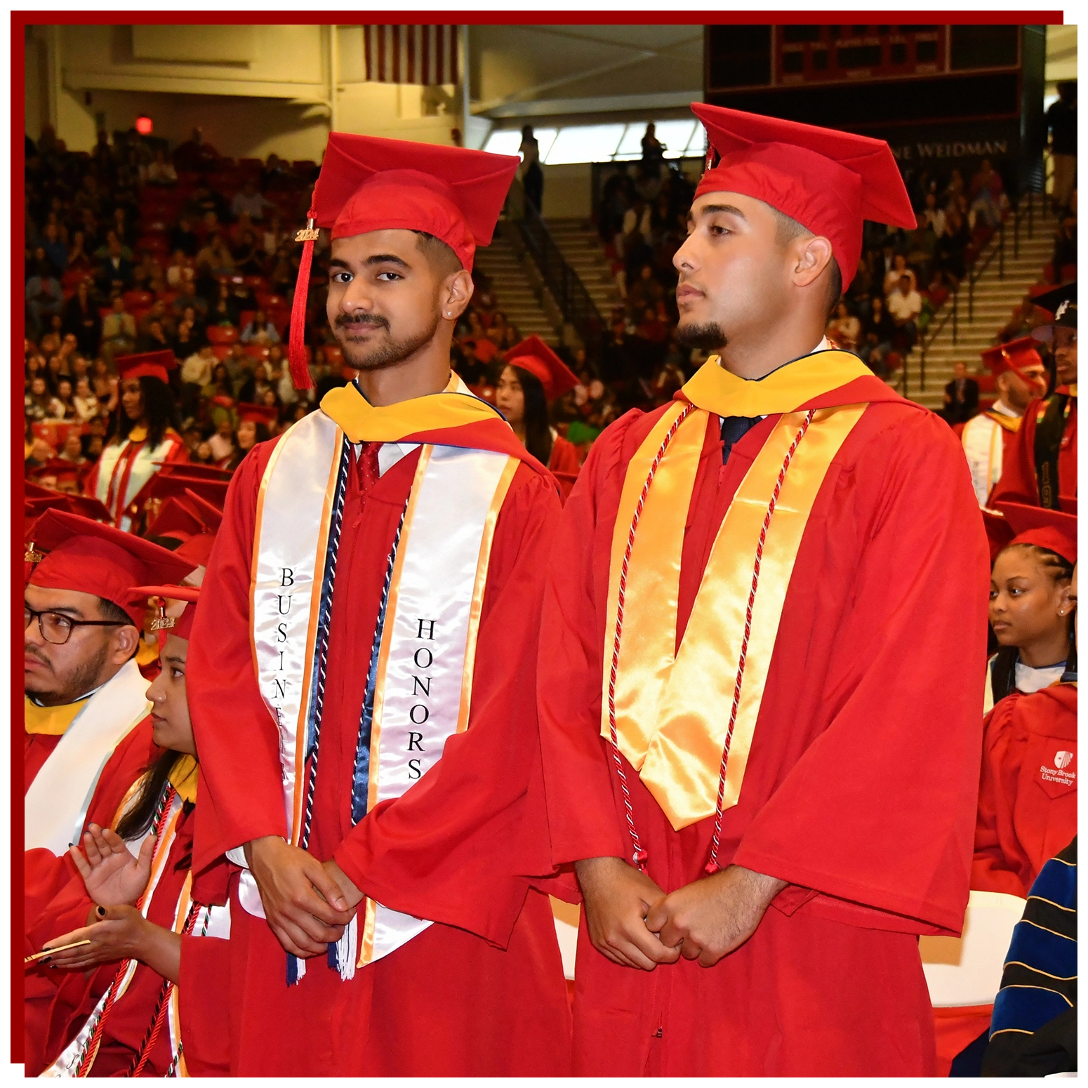 College of Business Graduate Walking Across the Stage with Diploma in hand