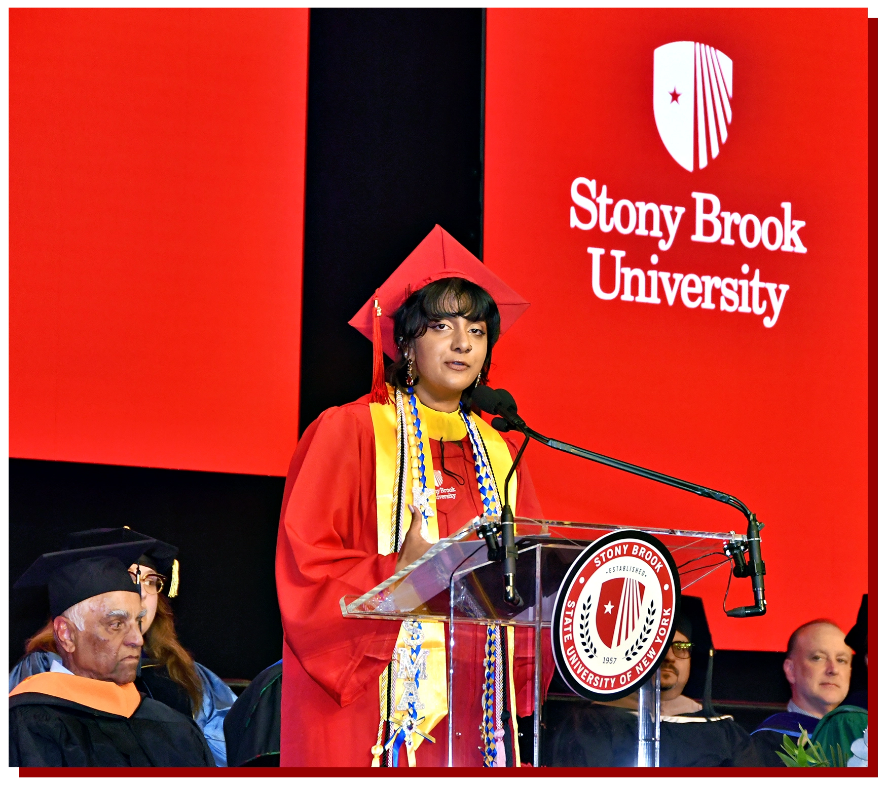 College of Business Graduate Walking Across the Stage with Diploma in hand