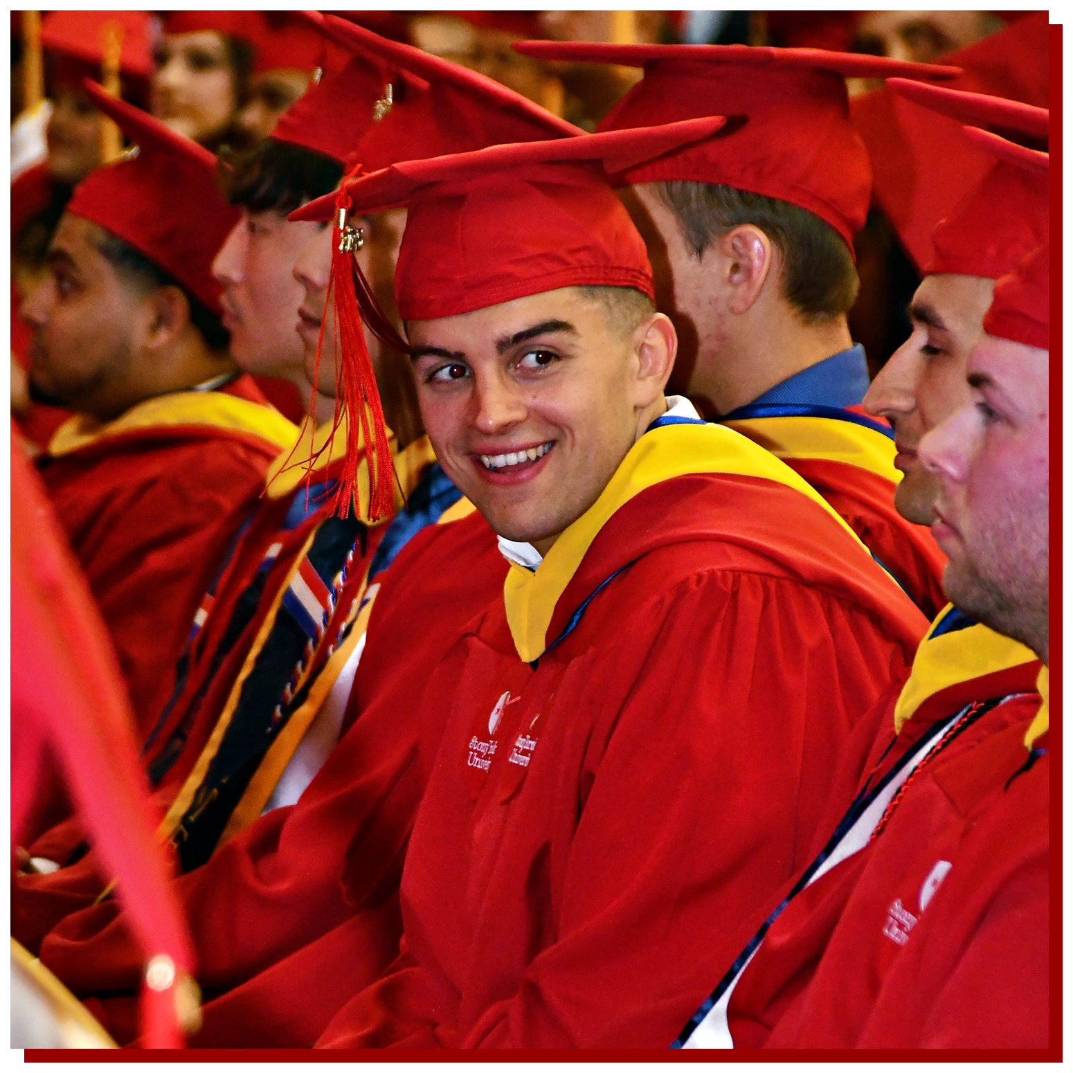 College of Business Graduate Walking Across the Stage with Diploma in hand