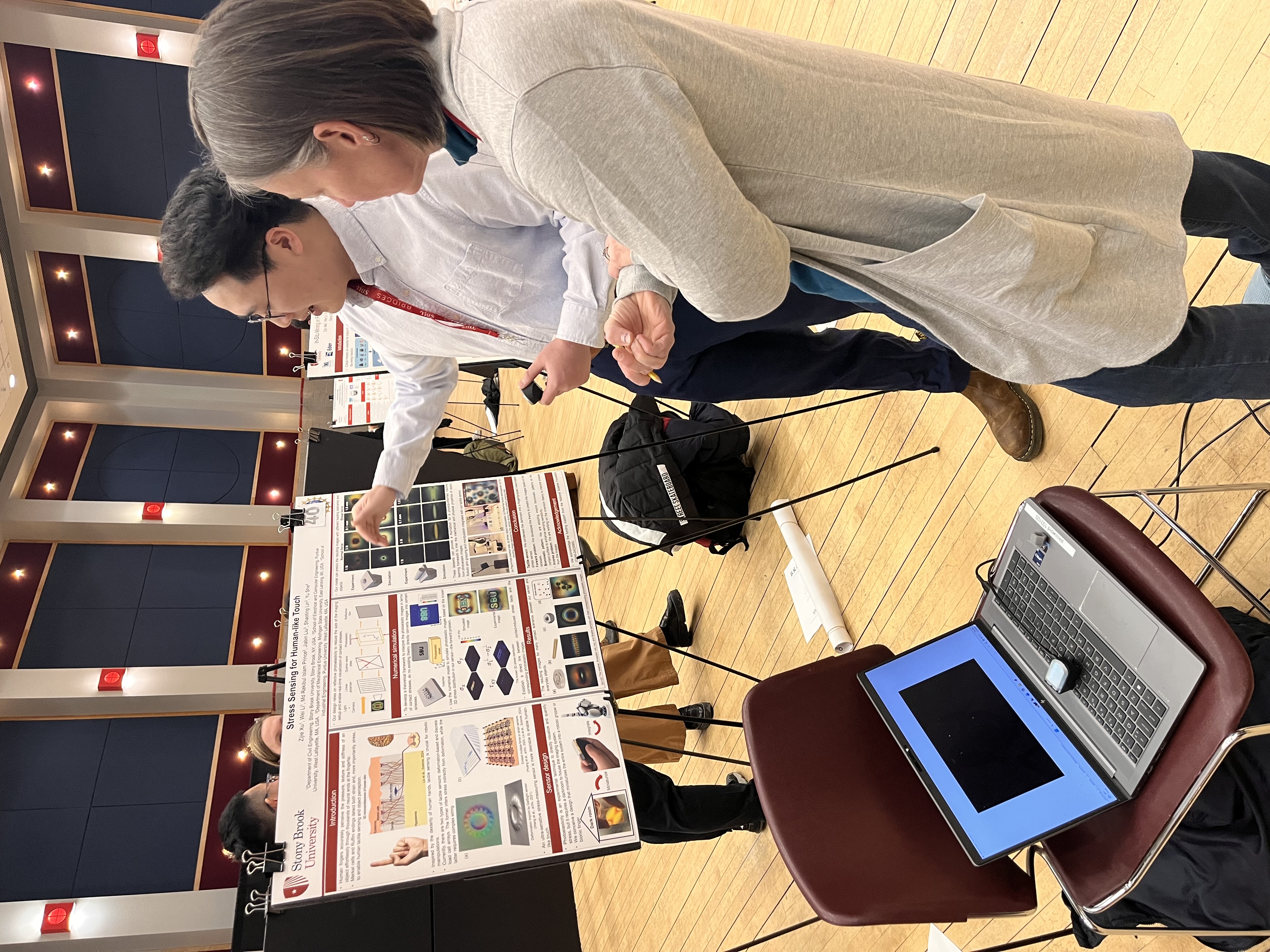 Z. Xu presenting poster to faculty