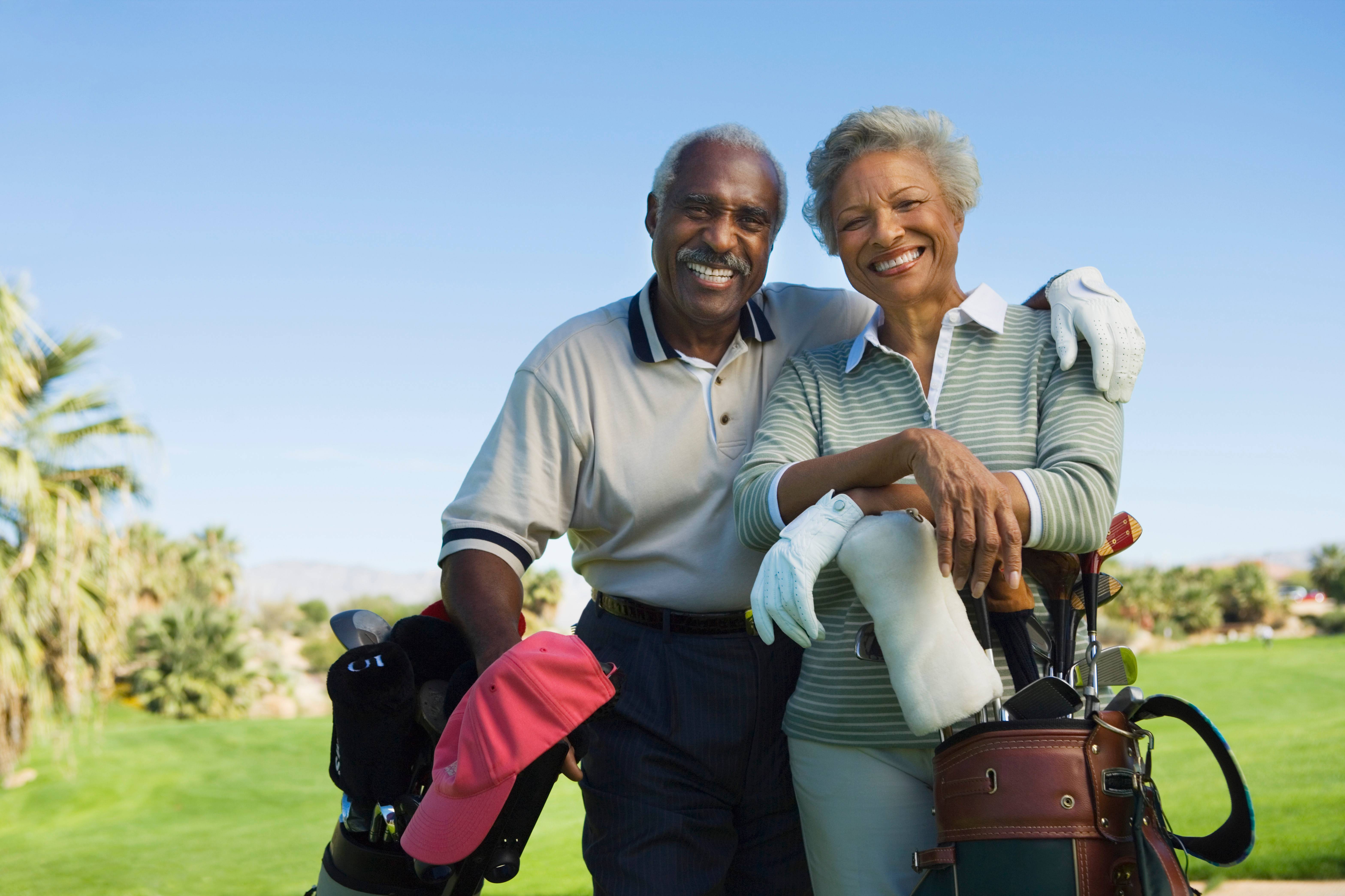 Elderly couple golfing