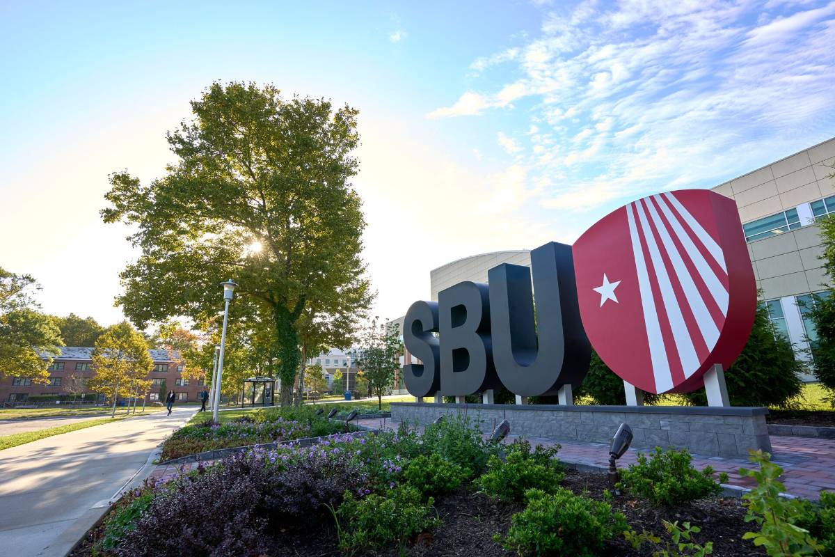 A large sign at Stony Brook University depicting the letters "SBU" and the university logo