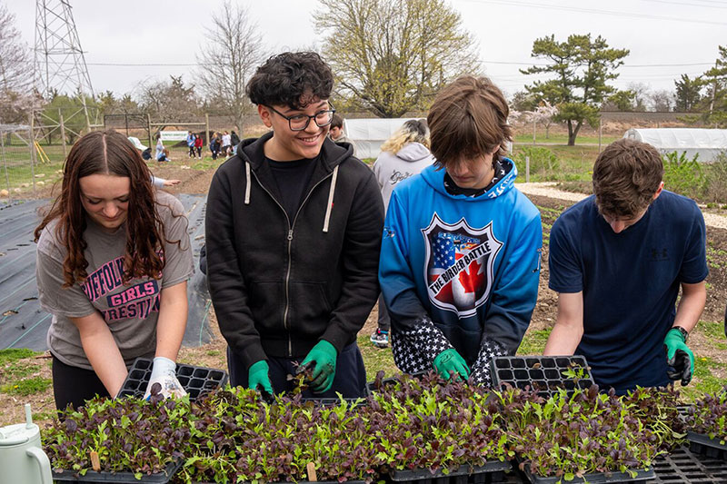 Students learning about environmental science through a hands-on gardening project
